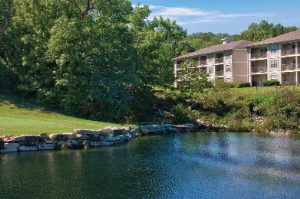 A man plays on a waterfront golf course at WorldMark Branson, a timeshare resort in Branson, Missouri. 